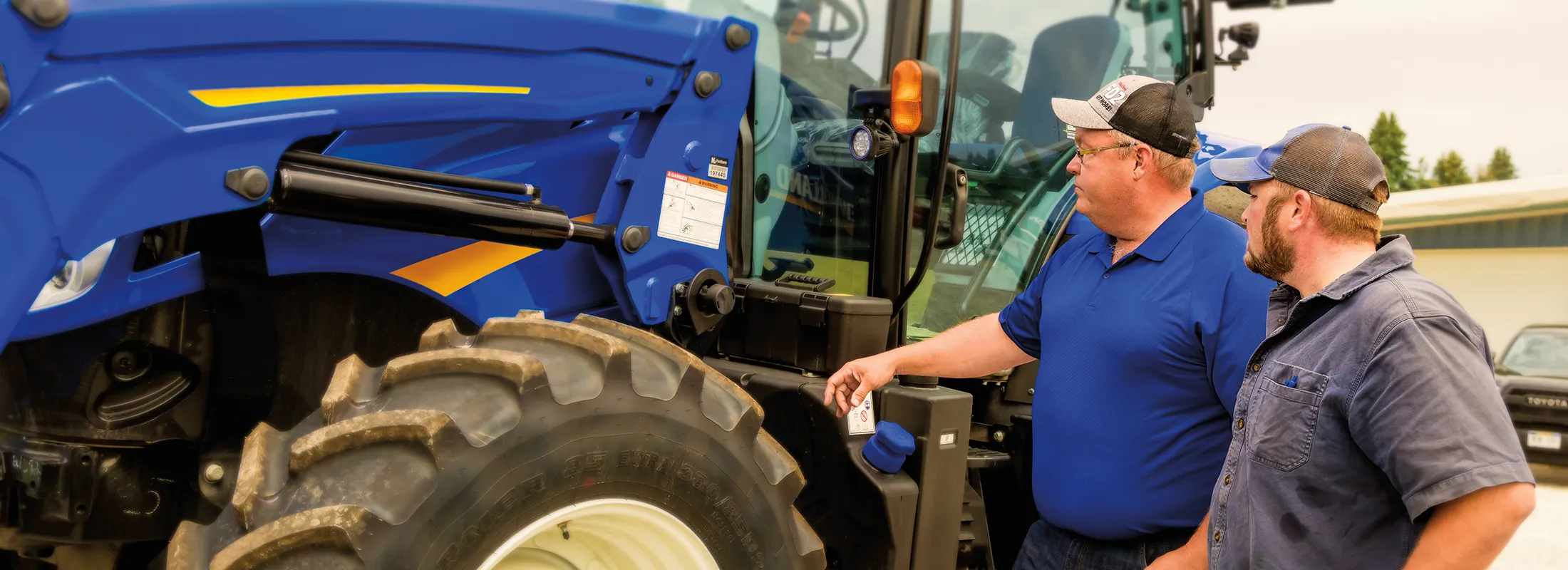 two men looking at a tractor