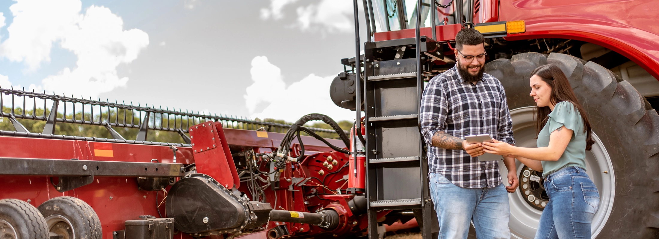People standing in front of ag equipment