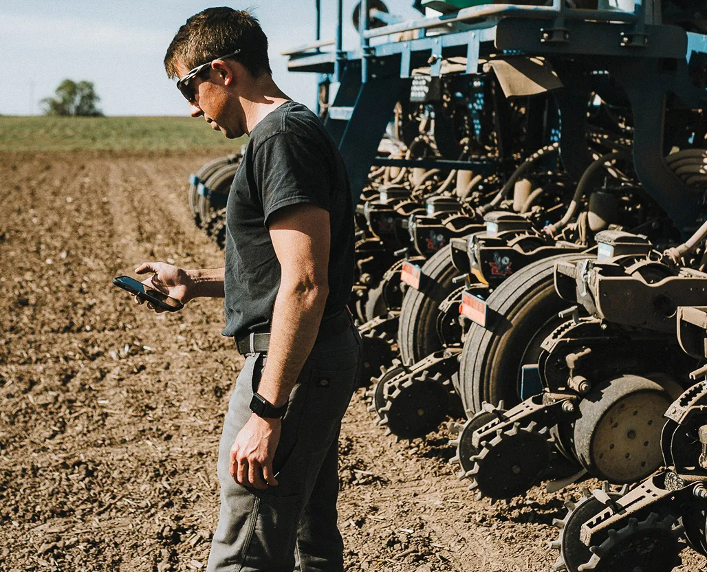man using mobile phone in field