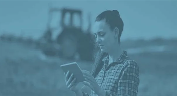 woman using digital tablet in field